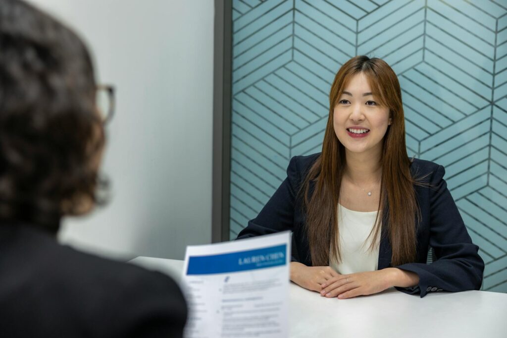 part time jobs international students uk — Young woman in a business meeting with an interviewer, showcasing confidence and p