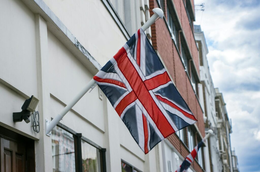 uk flag visa — Union Jack flag mounted on a building in London street, England.