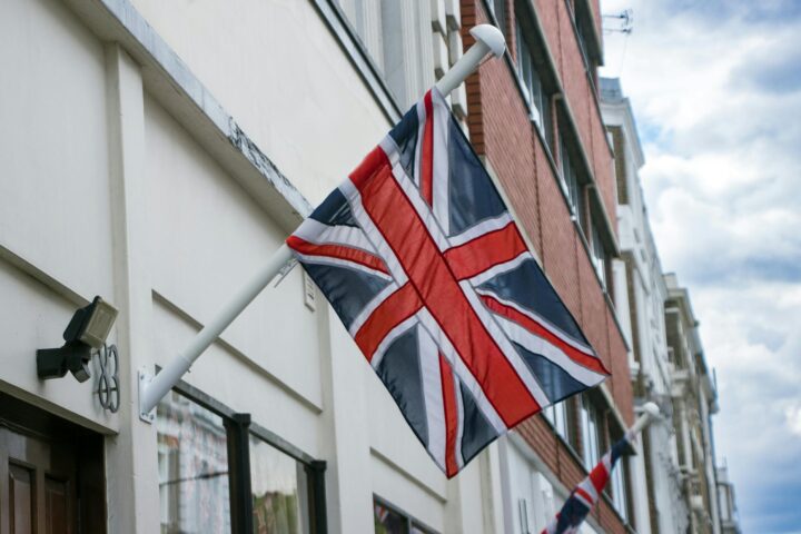 uk flag visa — Union Jack flag mounted on a building in London street, England.