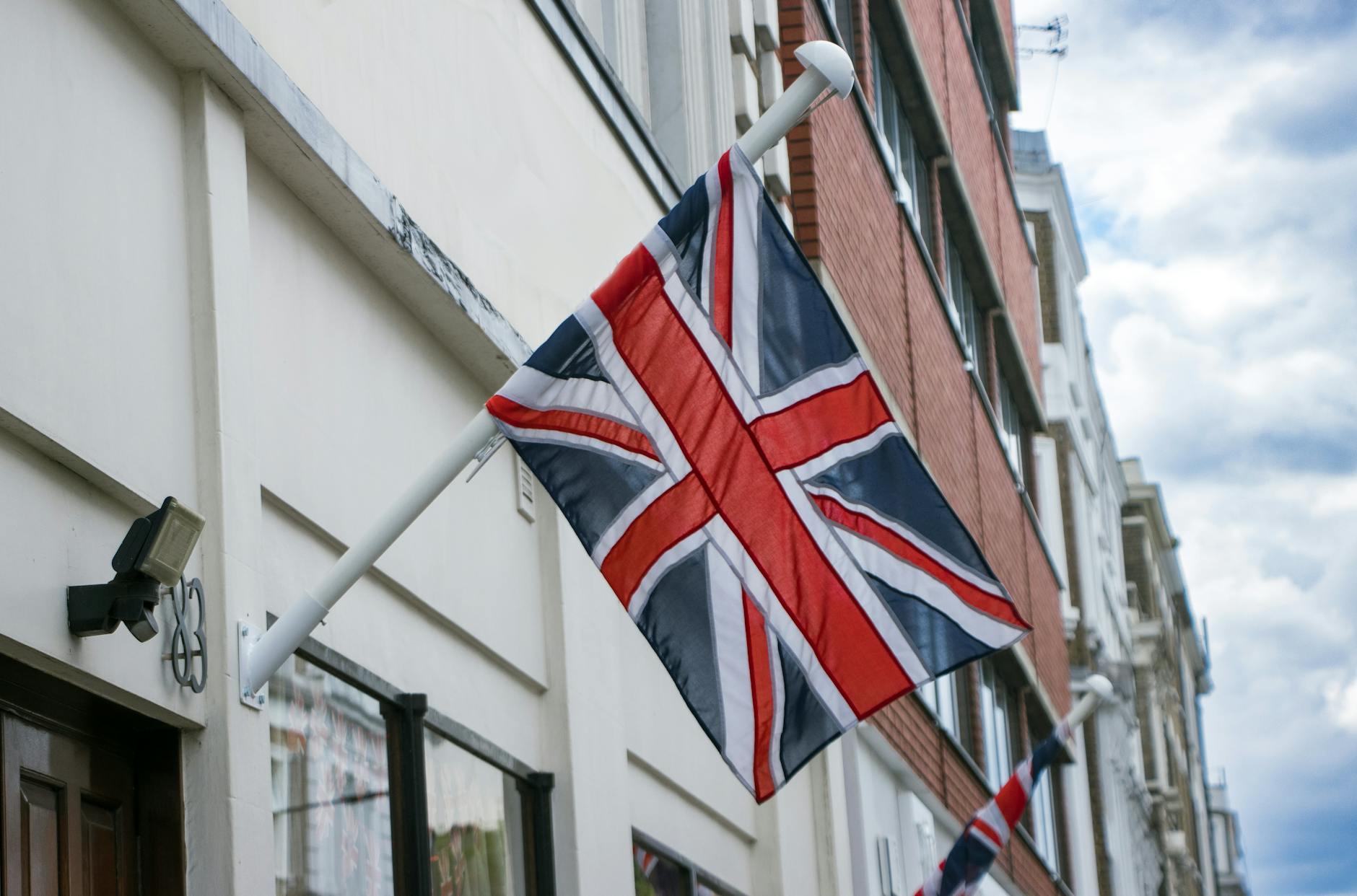 uk flag visa — Union Jack flag mounted on a building in London street, England.