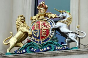 uk Immigration Reforms — Close-up of the Royal Coat of Arms featuring a lion and unicorn on a Melbourne building facade.